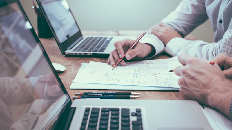 Bookkeeper reviewing client invoices and payment records for fraud prevention